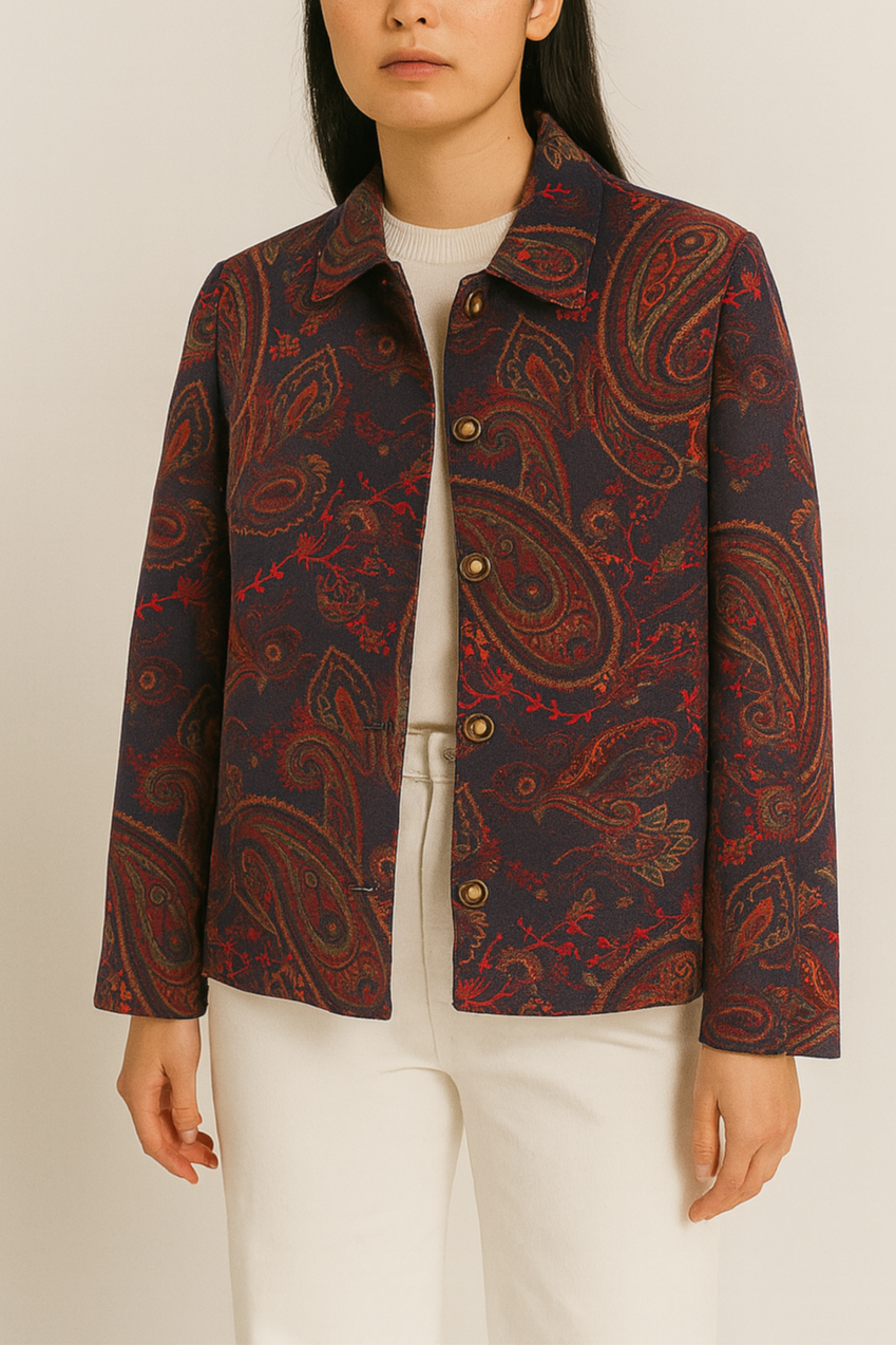 Person wearing a patterned jacket on a plain background