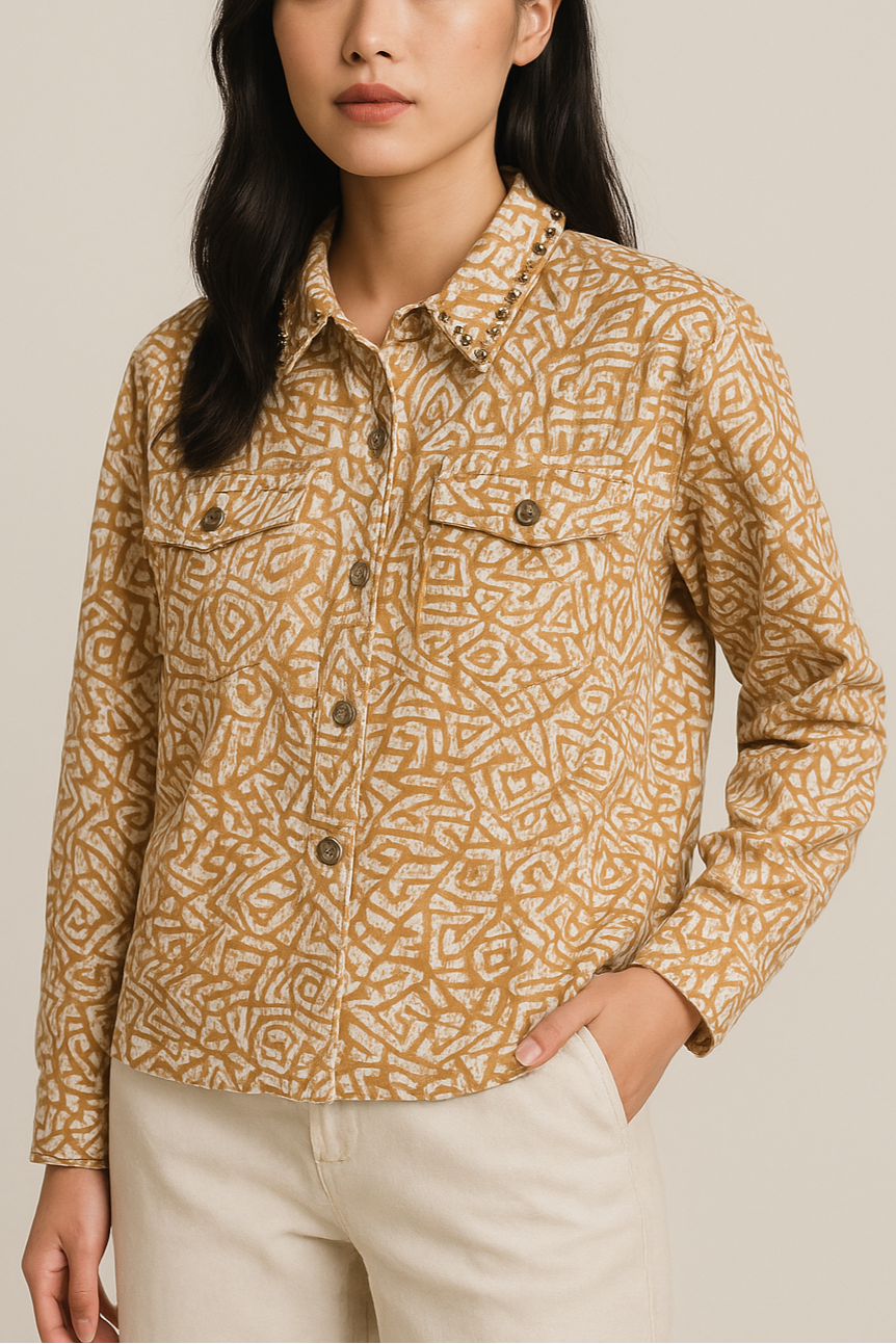 Woman wearing a patterned shirt against a beige background