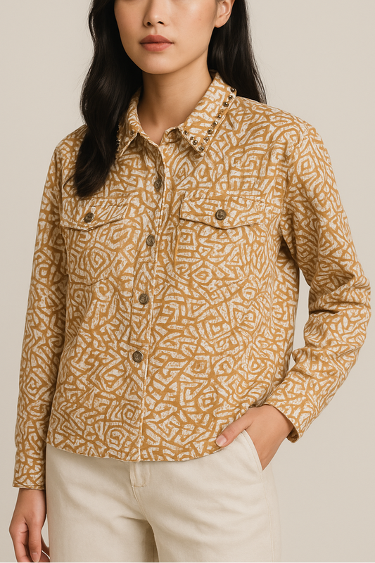 Woman wearing a patterned shirt against a beige background